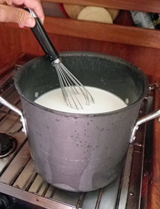 Stirring the buttermilk starter into the warmed milk.