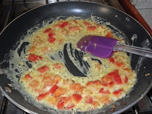 The flour is added to the sweated vegetables and oil an cooked.