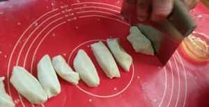 After kneading the tortilla dough is cut into equal pieces. 12 pieces for medium tortillas, 16 for small.