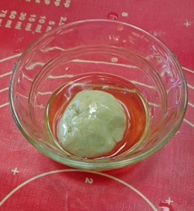 The dough is formed into balls and then coated with lard.