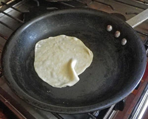 The tortillas are cooked quickly on a medium hot dry pan, or a griddle.
