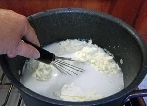 The powdered milk is dissolved in the pot.