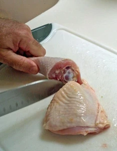 Separate the thigh and the drumstick by cutting through the joint.