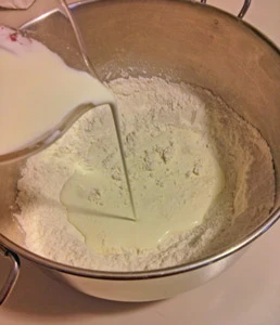 Cream is poured into the self-rising flour.