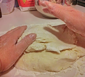 The dough is lightly kneaded and shaped to the right thickness.