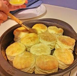 After baking the biscuits are brushed with melted butter.