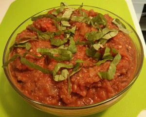 Finished eggplant caponata garnished with fresh basil.