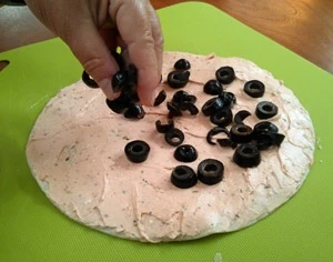 Sprinkle your contrasting layer over the sticky layer, stopping a half inch from the edges